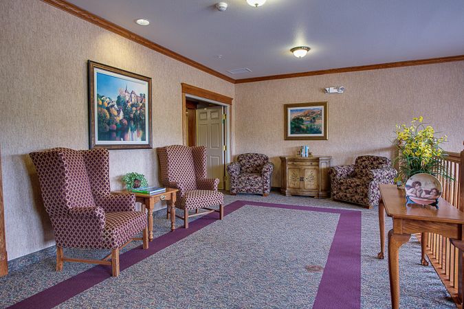 A cozy living room with comfortable seating and decorative artwork on the walls.