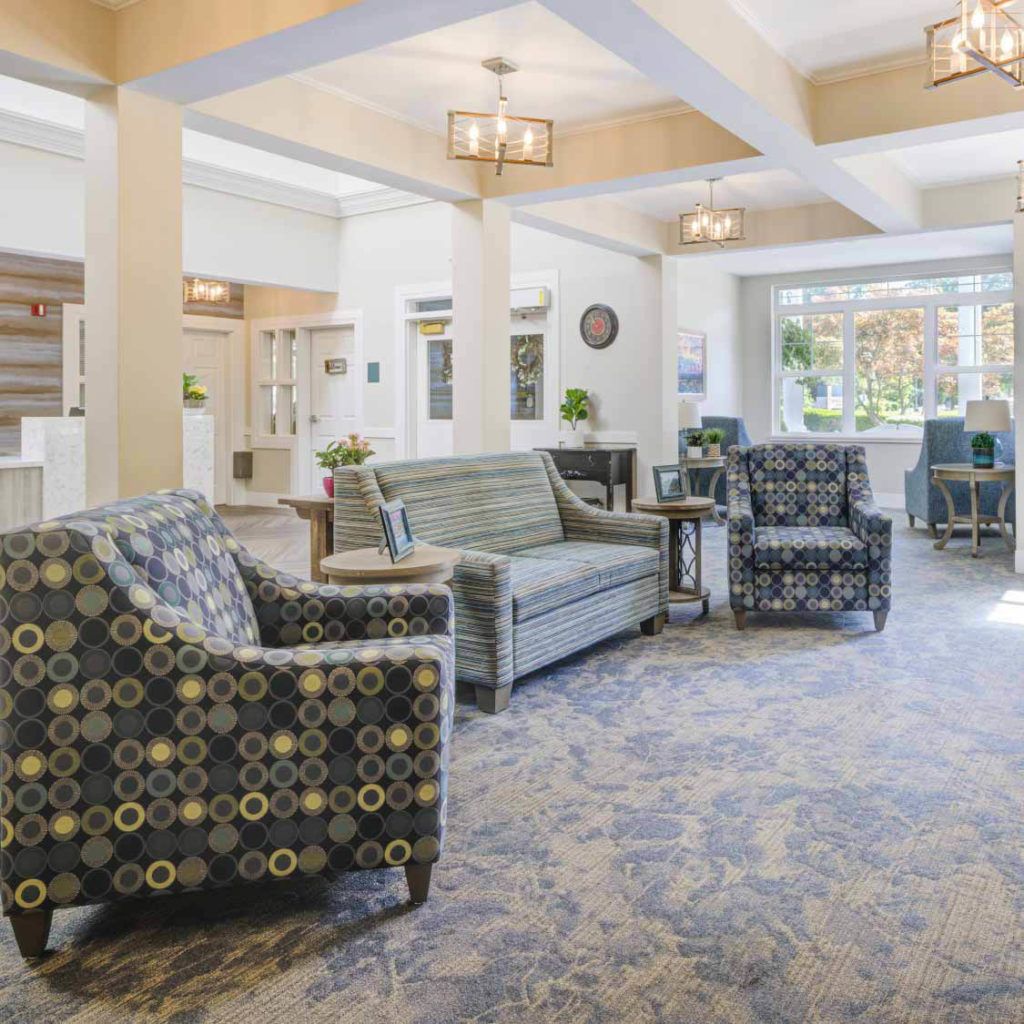 A spacious and well-lit lobby with comfortable seating arrangements, including sofas and chairs.