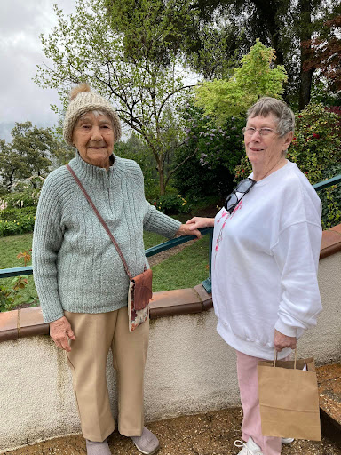 Two elderly women enjoying a day out in a scenic location.