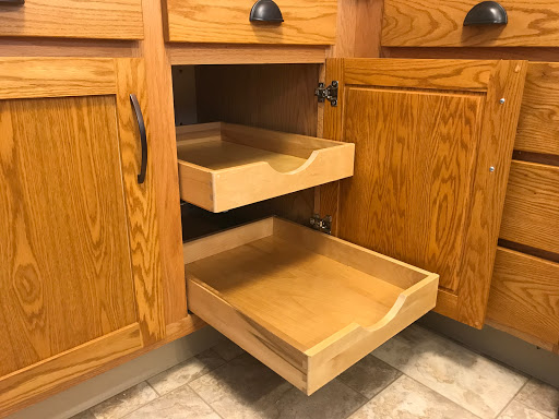 A view of wooden kitchen cabinet drawers showcasing organized storage space.