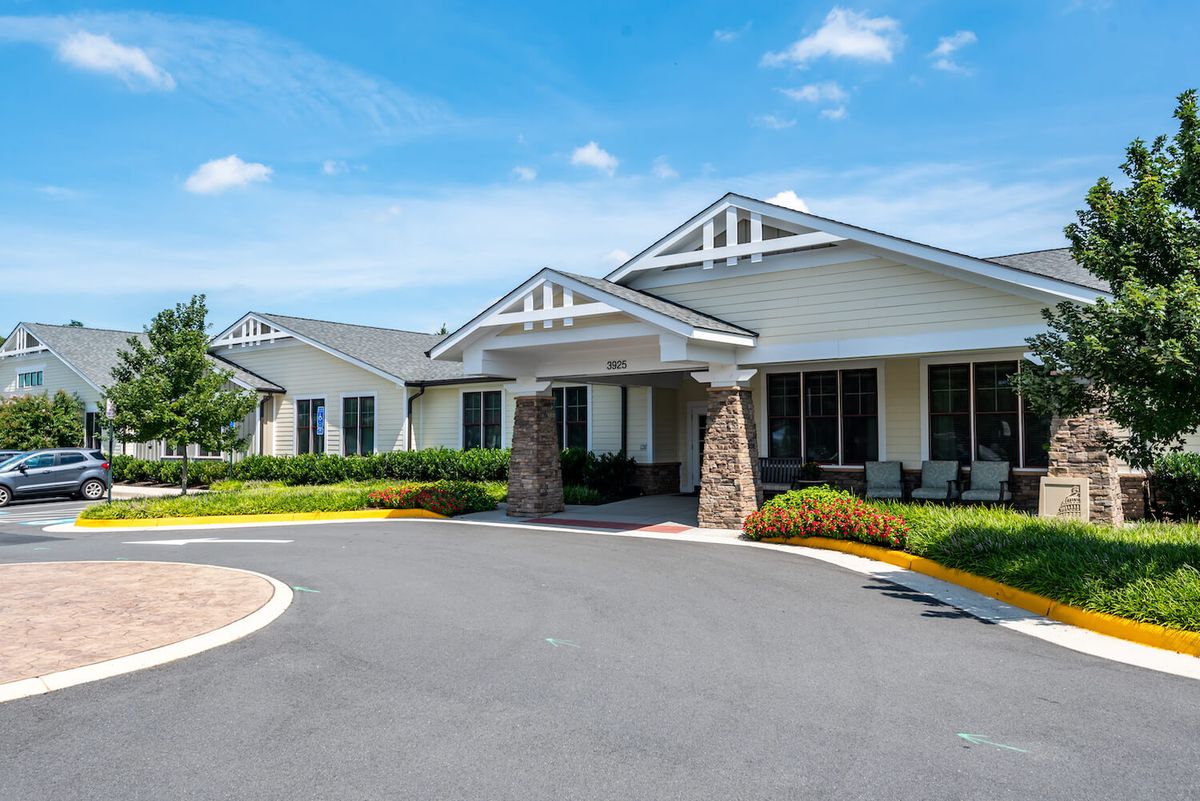 A well-maintained building with a welcoming entrance and landscaped surroundings on a sunny day.