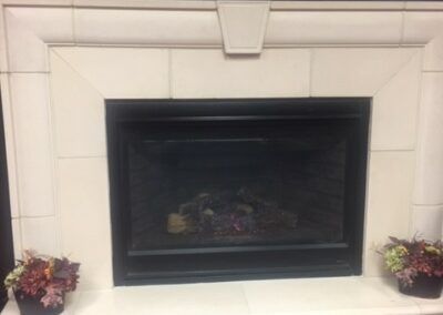 A cozy indoor fireplace with a tiled surround.