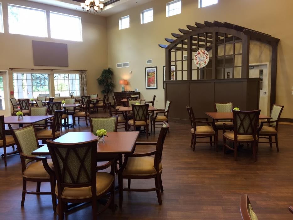 Spacious dining area with neatly arranged tables and chairs, featuring elegant interior design.