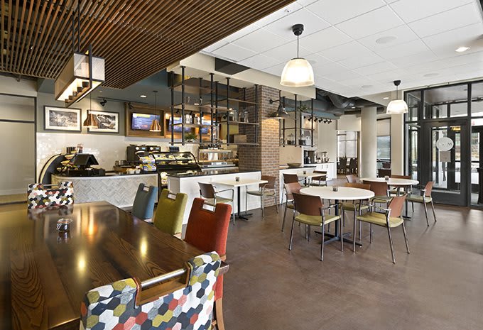 A modern cafe interior with stylish seating and ambient lighting.