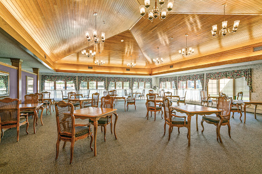 A spacious dining area with elegant wooden finishes and ample natural light.
