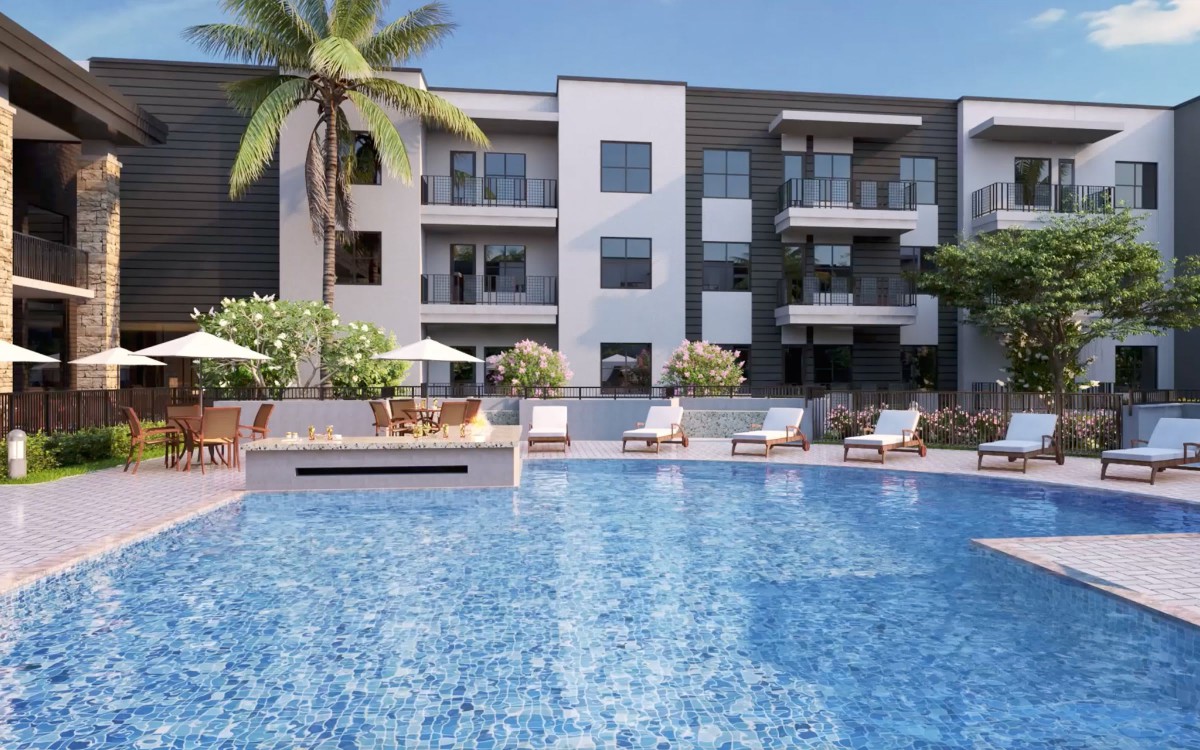 Modern apartment complex with a large swimming pool surrounded by sun loungers and palm trees.