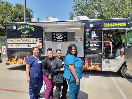 A cheerful group of women enjoying their time at a taco food truck.
