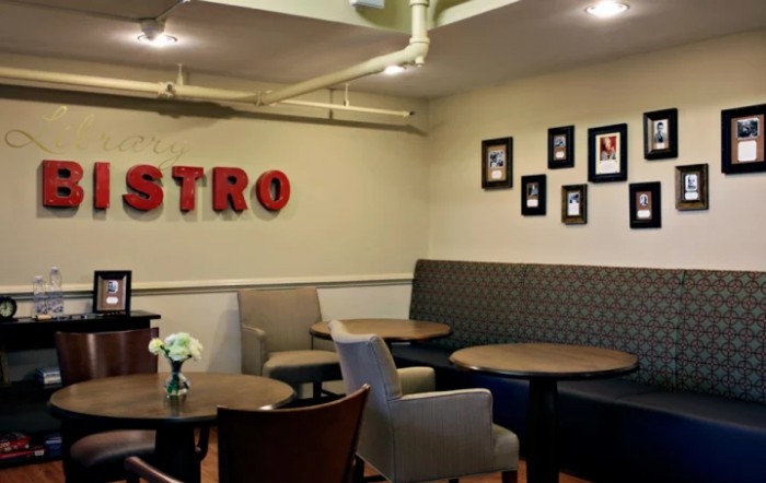 Cozy bistro seating area with tables and chairs, featuring wall decor.
