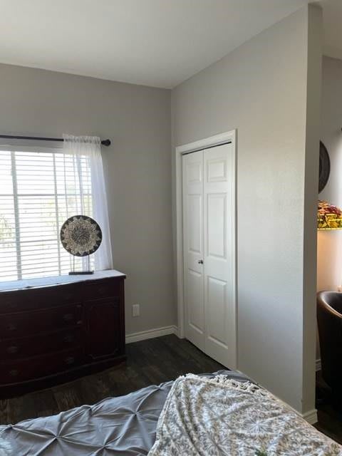 A cozy bedroom with a dresser and window letting in natural light.