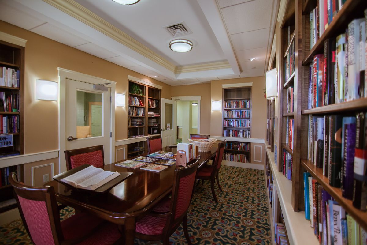 A cozy library room with elegant furnishings and an abundance of books.
