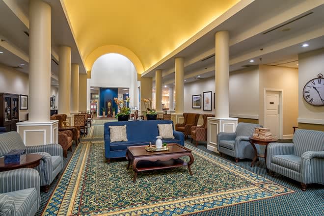 A spacious hotel lobby with comfortable seating and elegant decor.