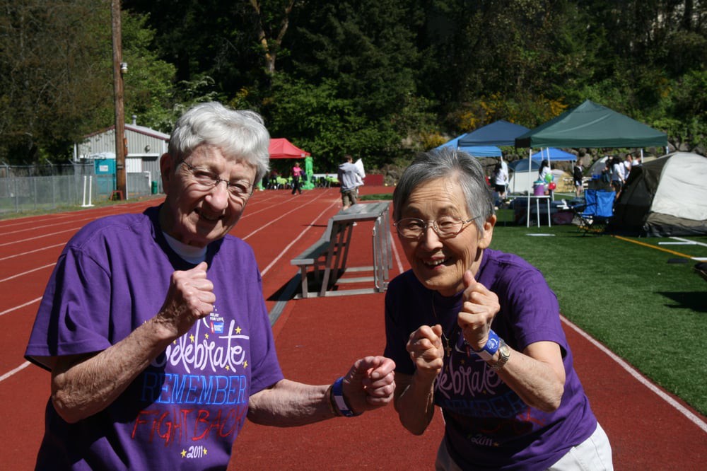 Two seniors enjoying an active day on the track.