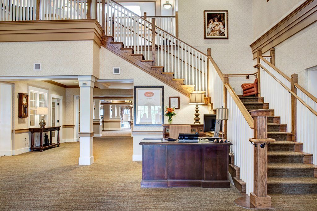 A welcoming lobby area featuring a reception desk and staircase.