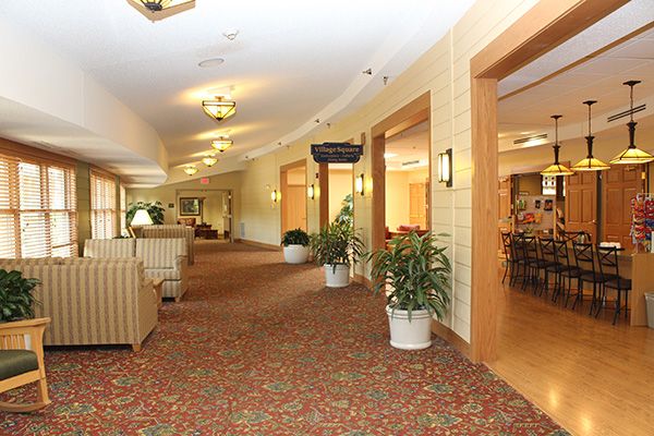 A spacious lobby featuring comfortable seating, decorative plants, and soft lighting.