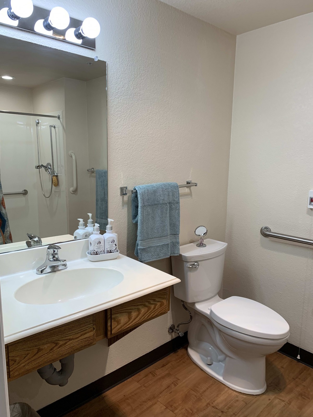 A clean and minimalistic bathroom with a sink, toilet, and mirror.