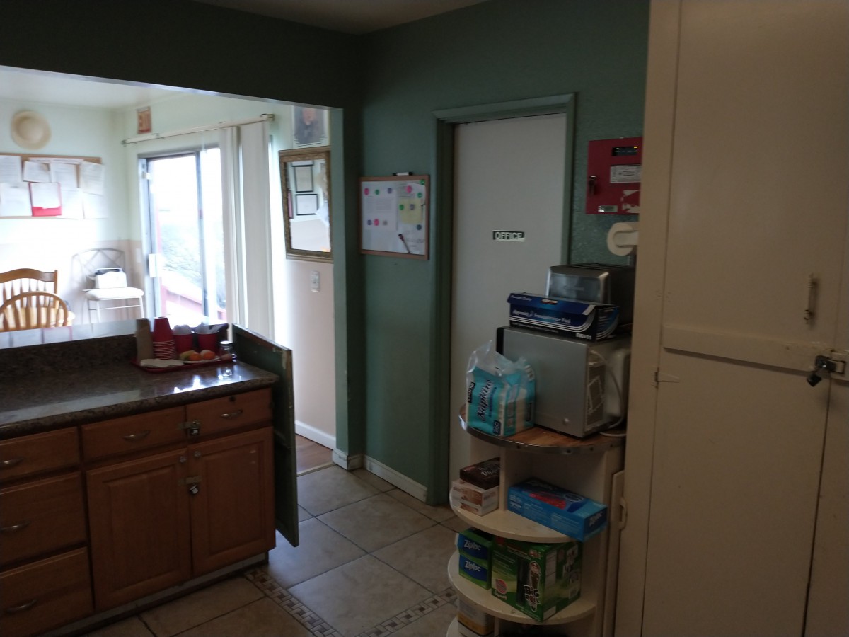 A kitchen with cabinets, countertops, and various appliances.