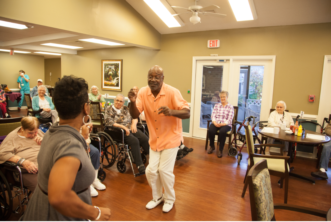 A lively dance activity taking place in a nursing home, engaging residents in a fun and energetic atmosphere.