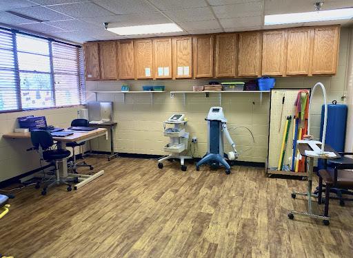 A spacious office area equipped with medical equipment and storage cabinets.