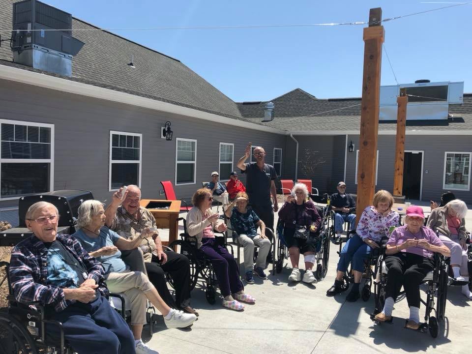 A group of seniors enjoying an outdoor gathering in the sun.