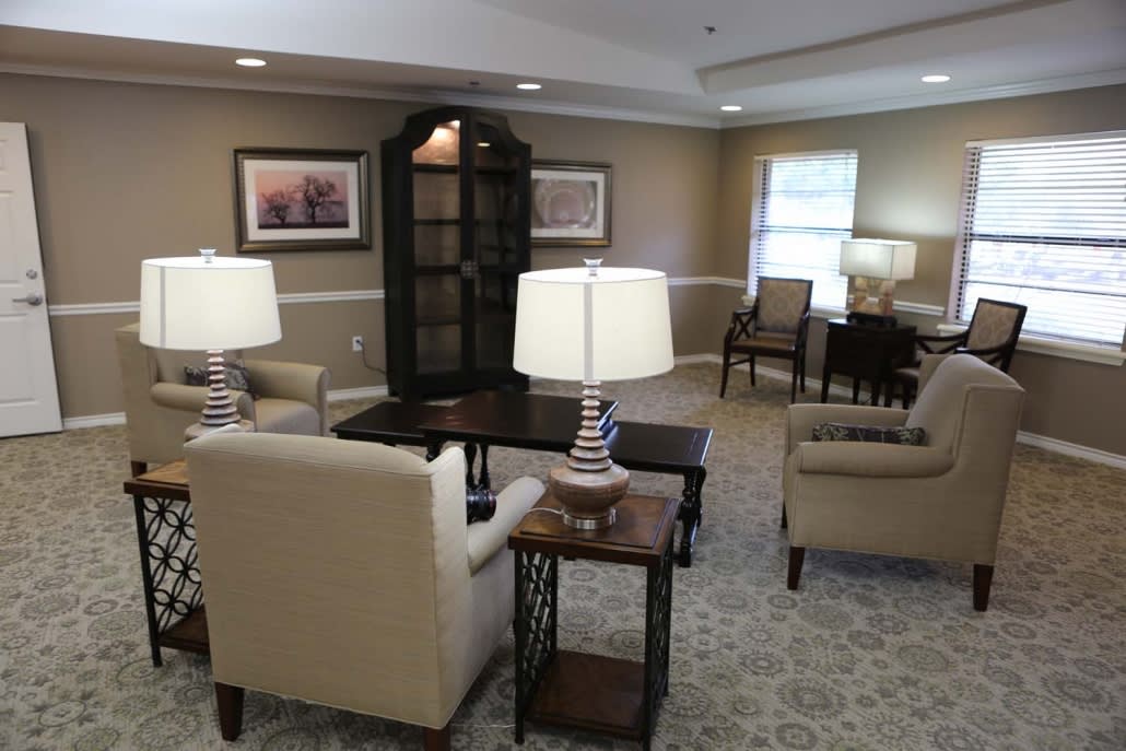 A cozy living room with comfortable seating, elegant lamps, and tasteful decor.