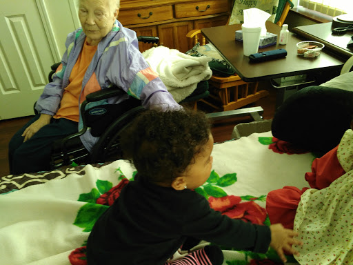 A heartwarming moment between an elderly woman and a child, showcasing the bond across generations.