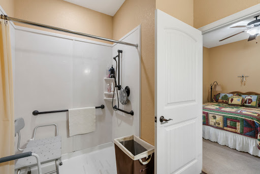 A modern bathroom featuring a glass shower enclosure and neatly organized space.