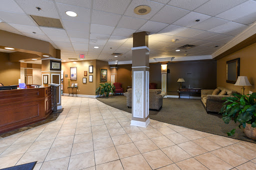A spacious hotel lobby featuring comfortable seating areas, elegant decor, and a welcoming atmosphere.