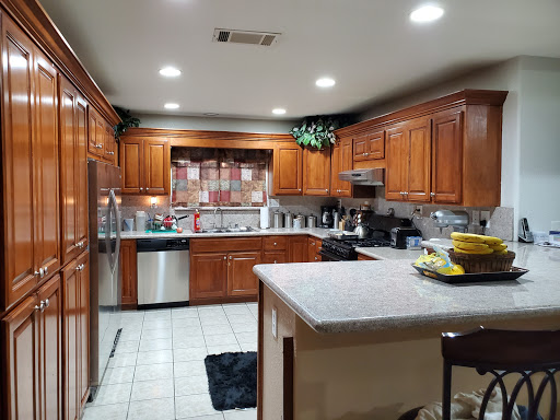 A modern kitchen featuring wooden cabinets and stainless steel appliances.