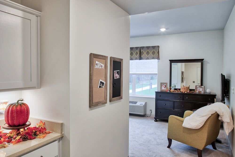 A modern living space with a bedroom view, featuring furniture and decor elements.