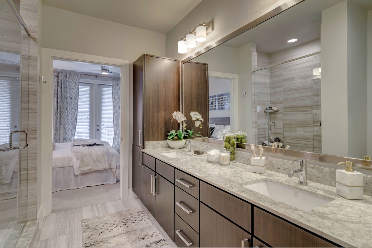A modern bathroom with a double-sink vanity and sleek design elements.