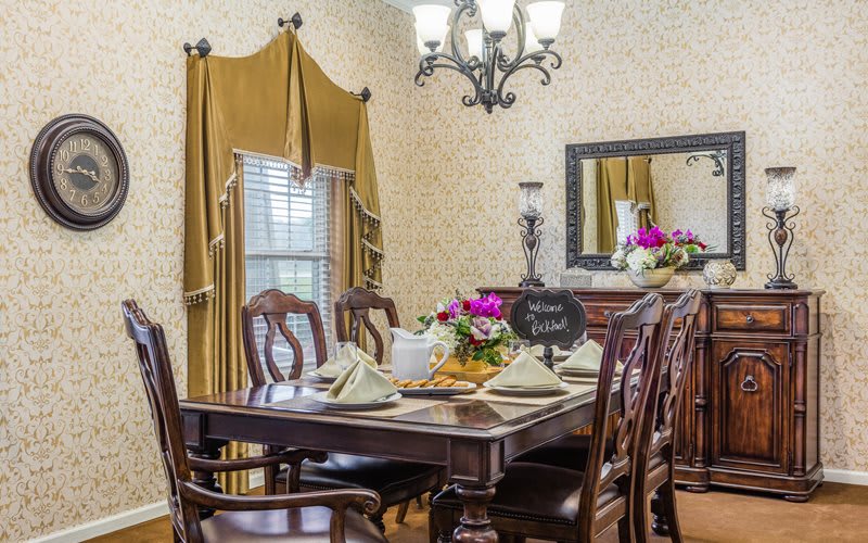 Elegant dining room with a set table and floral centerpieces.