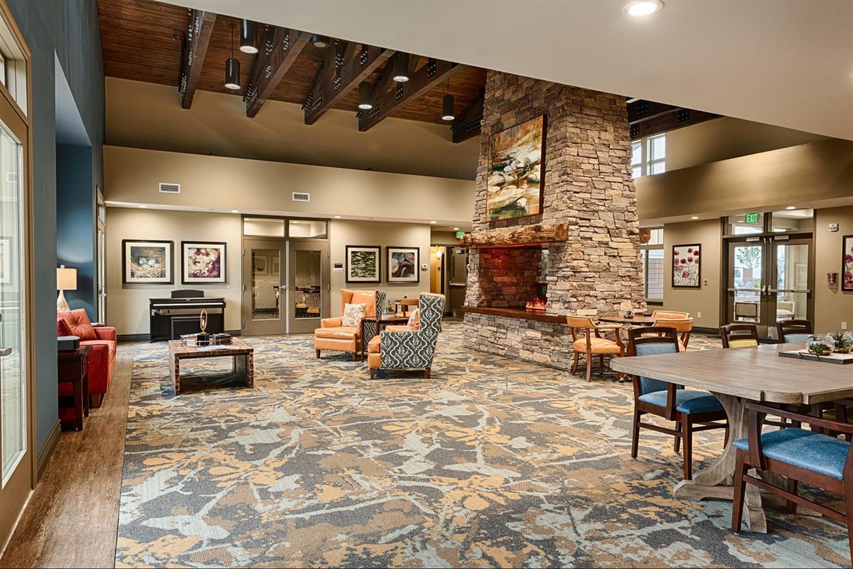 A spacious and modern lobby featuring a stone fireplace and comfortable seating.