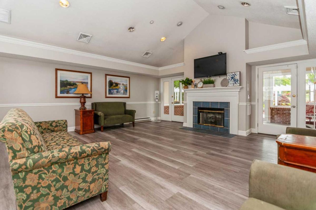 A cozy living room with a fireplace, television, and comfortable seating.