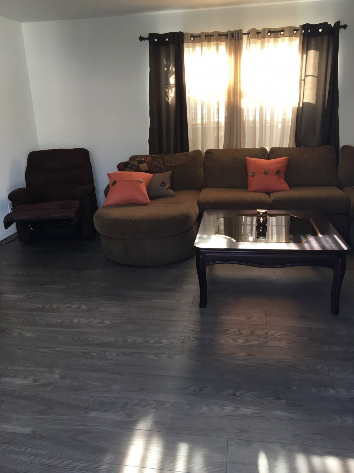 A cozy living room with a sectional sofa and coffee table.