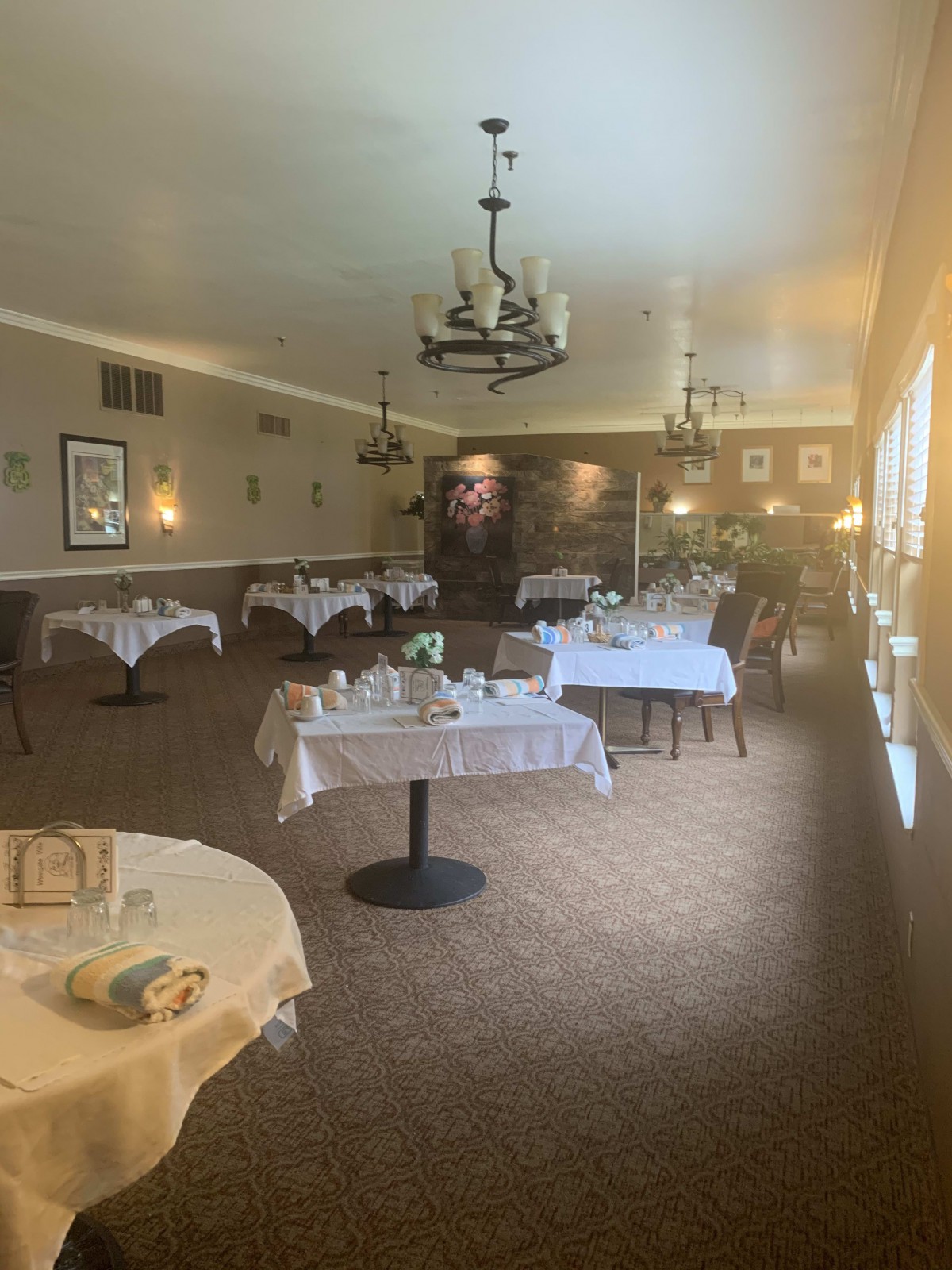 A cozy restaurant dining area with elegantly set tables and soft lighting.