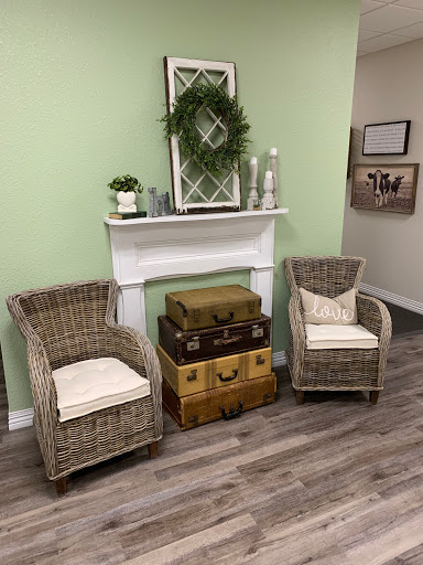 A cozy living room setup featuring wicker chairs and a decorative mantel.