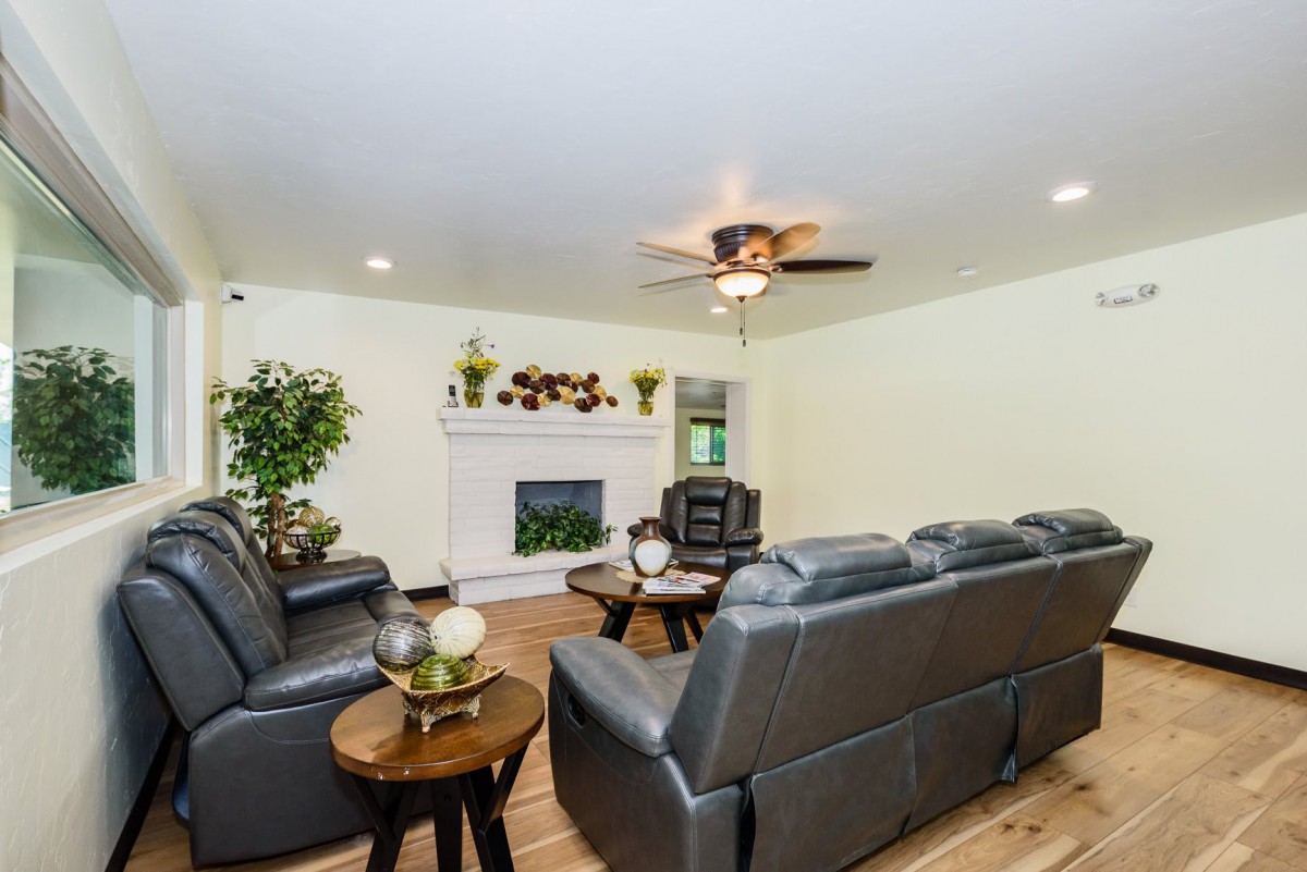 A cozy living room featuring a fireplace, comfortable seating, and decorative elements.