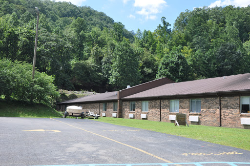 A serene view of a building nestled in a lush, green landscape.