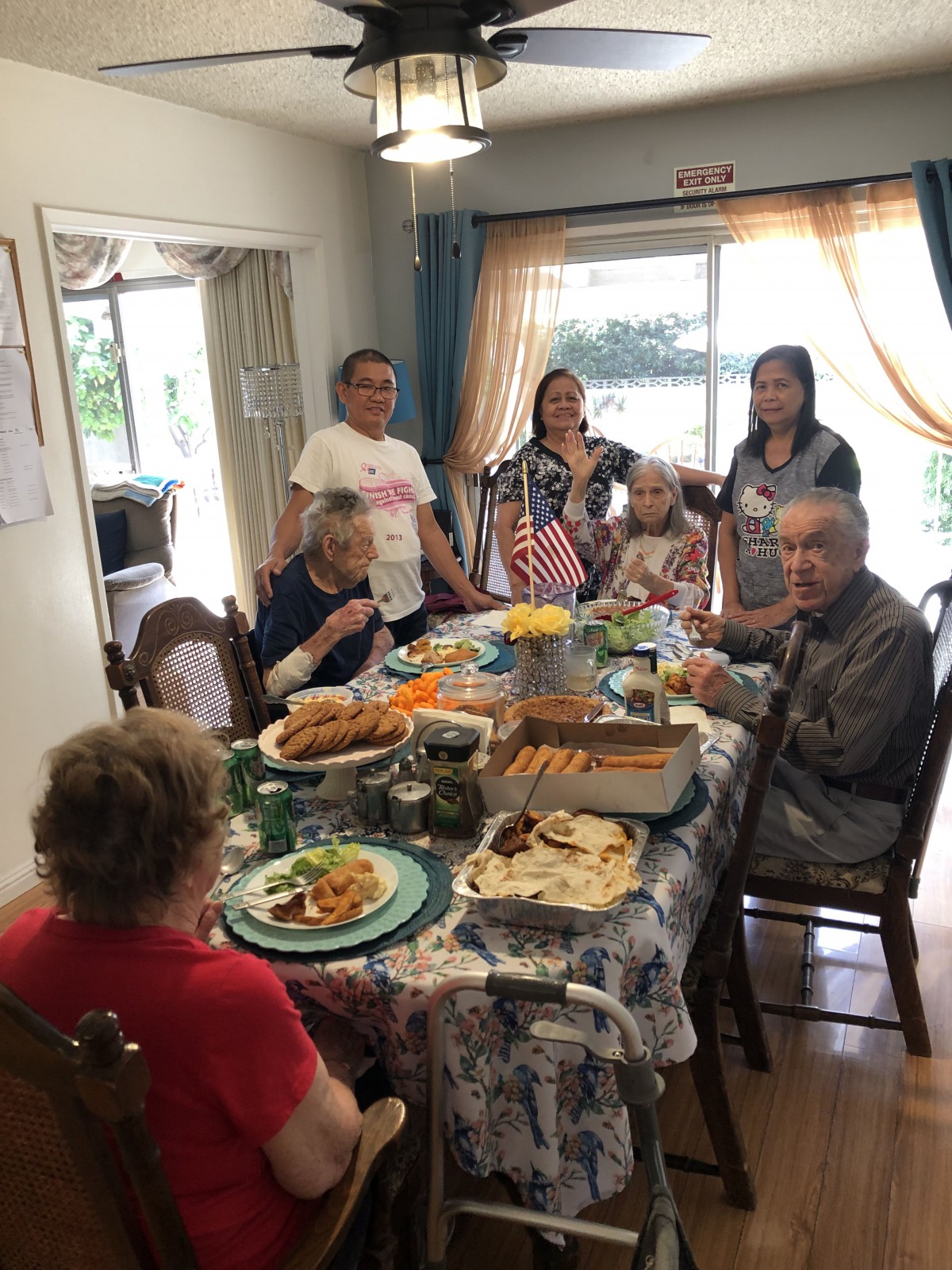 A family gathering around a dining table for a meal at home.