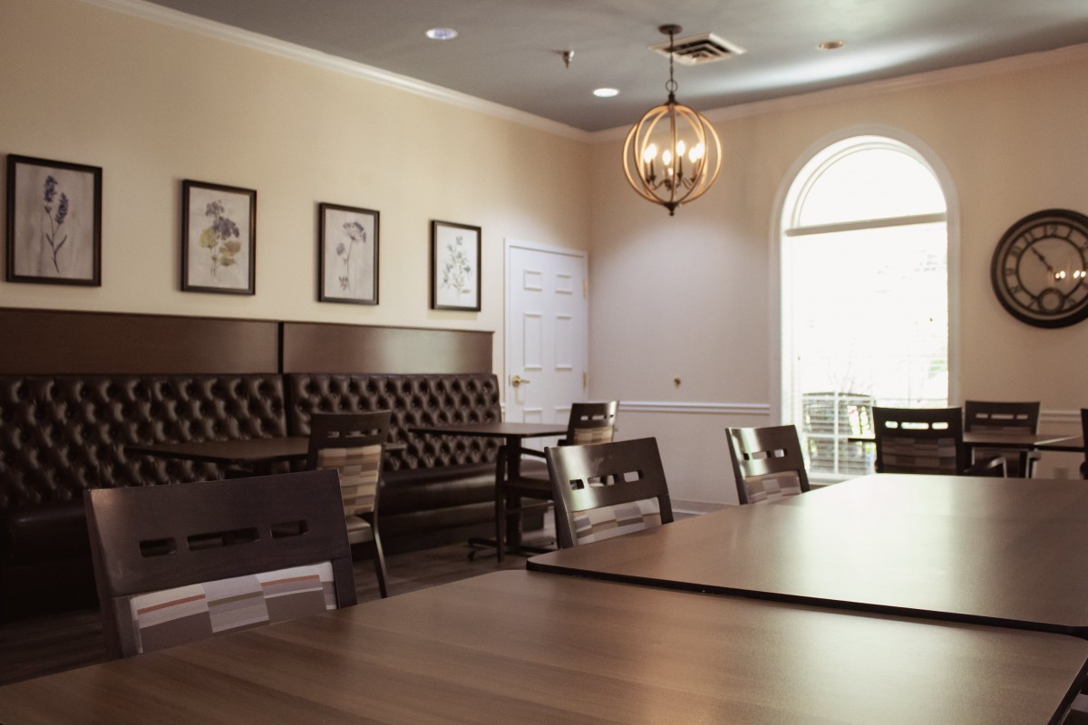 A cozy dining area with elegant seating and warm lighting.