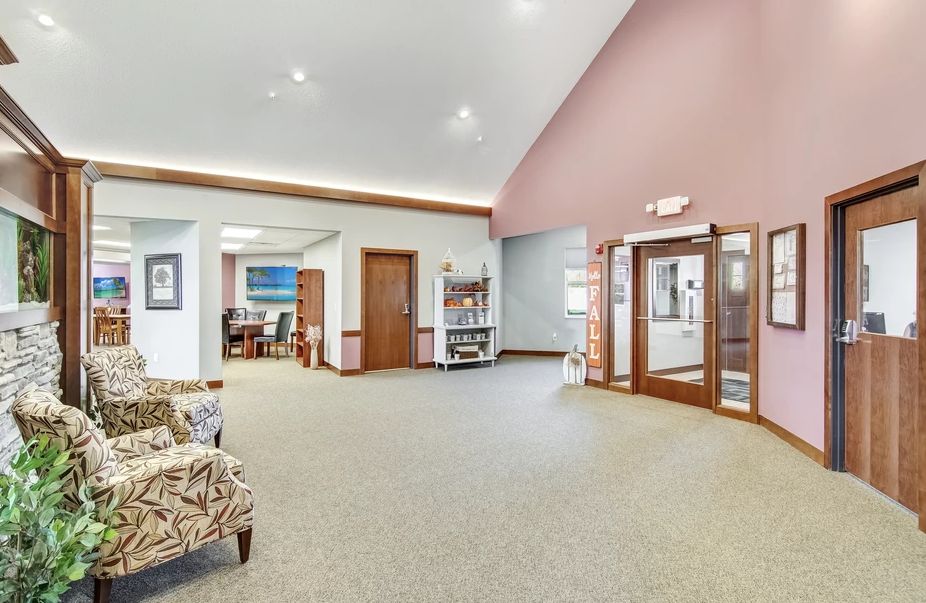 A spacious lobby area with seating and a reception desk.