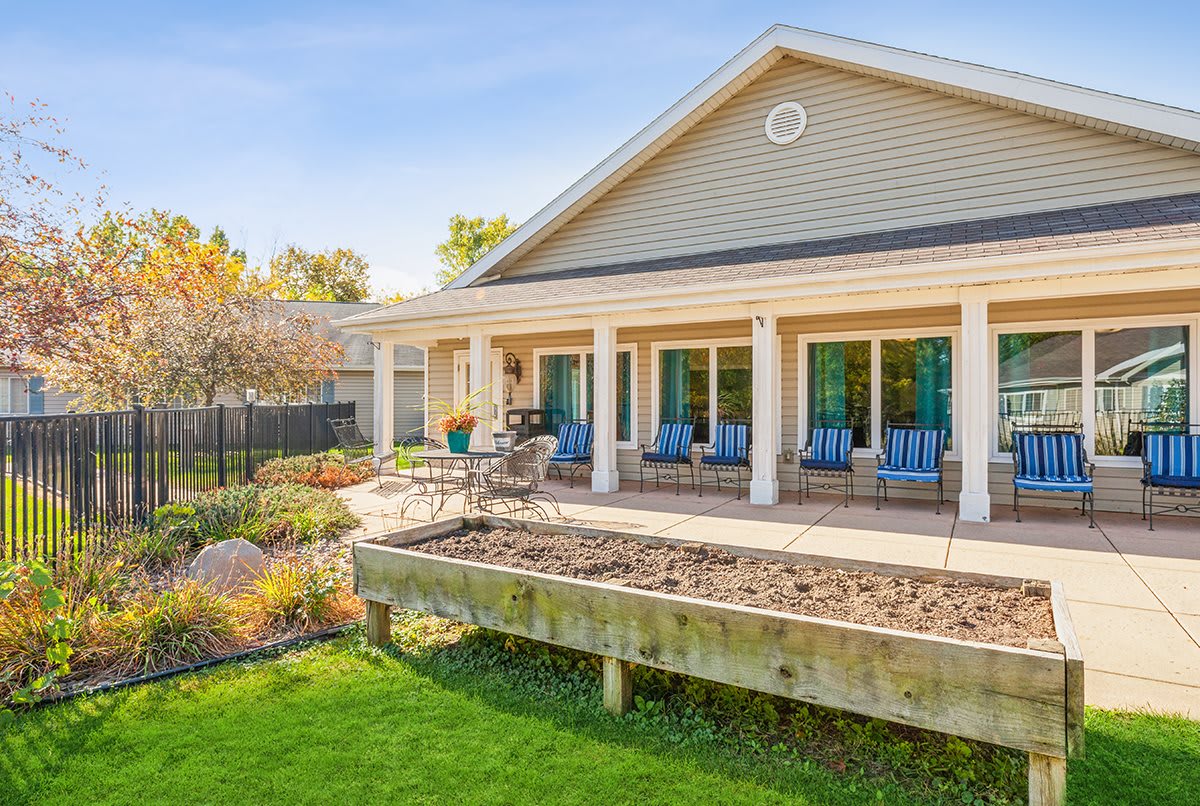 A beautiful house with a landscaped garden and a spacious patio area.