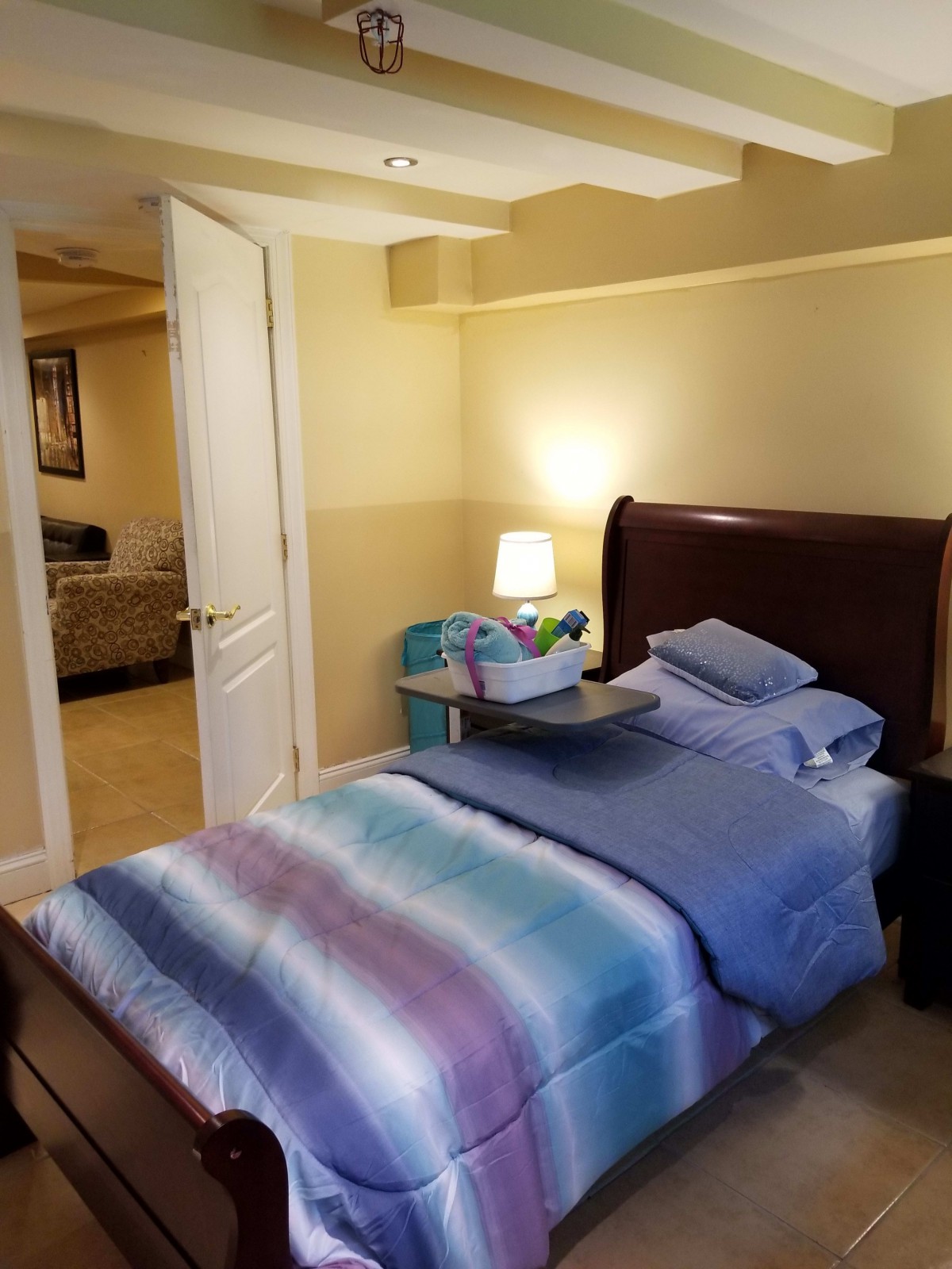 A cozy bedroom with a neatly made bed and soft lighting.