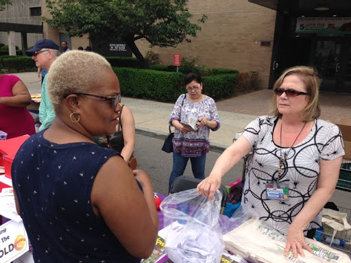 Community members engaging with vendors at a local outdoor market.