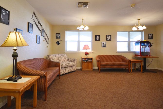 A cozy living room with a variety of seating options and decorative wall photos.