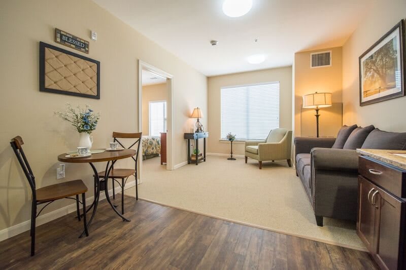 A cozy living room with a mix of comfortable seating and warm lighting.