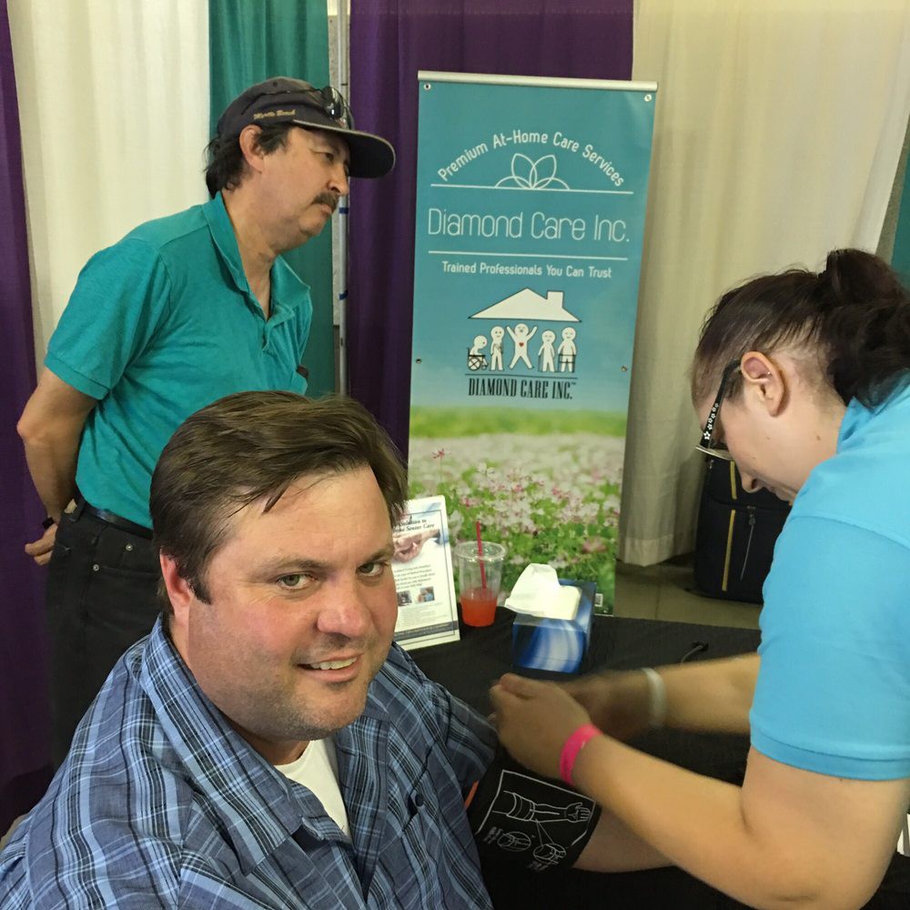 People interacting at a booth during an event.