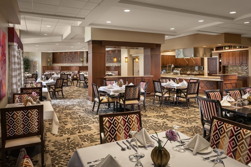 An elegantly decorated restaurant dining room with neatly arranged tables and chairs.