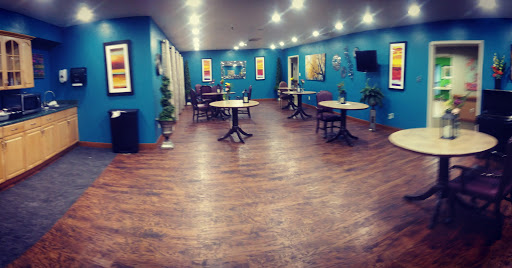 A modern restaurant interior with blue walls, stylish decor, and a warm ambiance.