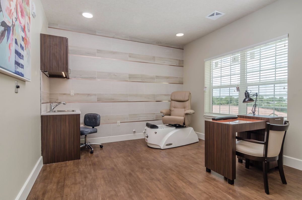 A modern nail salon with a pedicure chair and clean interior design.